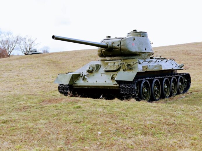 green battle tank on green grass field during daytime