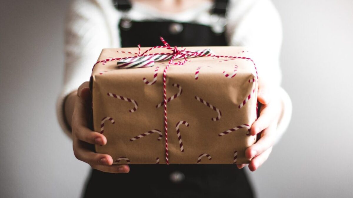 person showing brown gift box