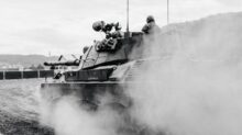 grayscale photo of soldiers on battle tank