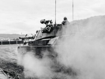 grayscale photo of soldiers on battle tank