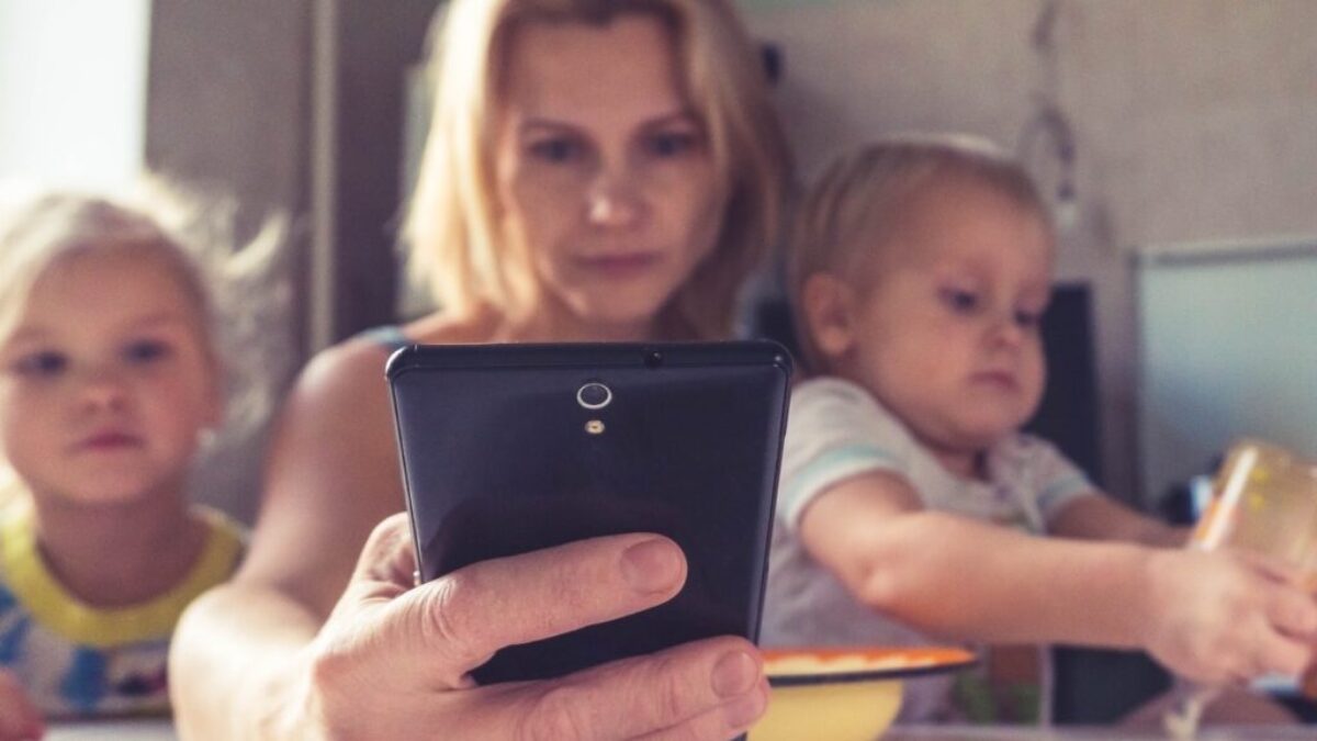 woman in white shirt holding black ipad