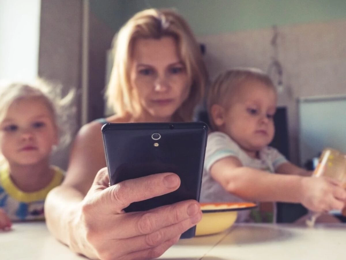 woman in white shirt holding black ipad