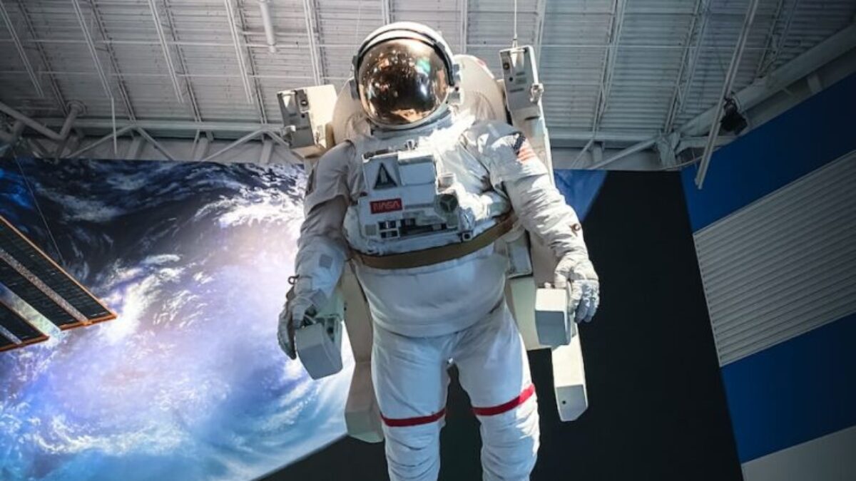 man in white and black suit standing on white and blue floor