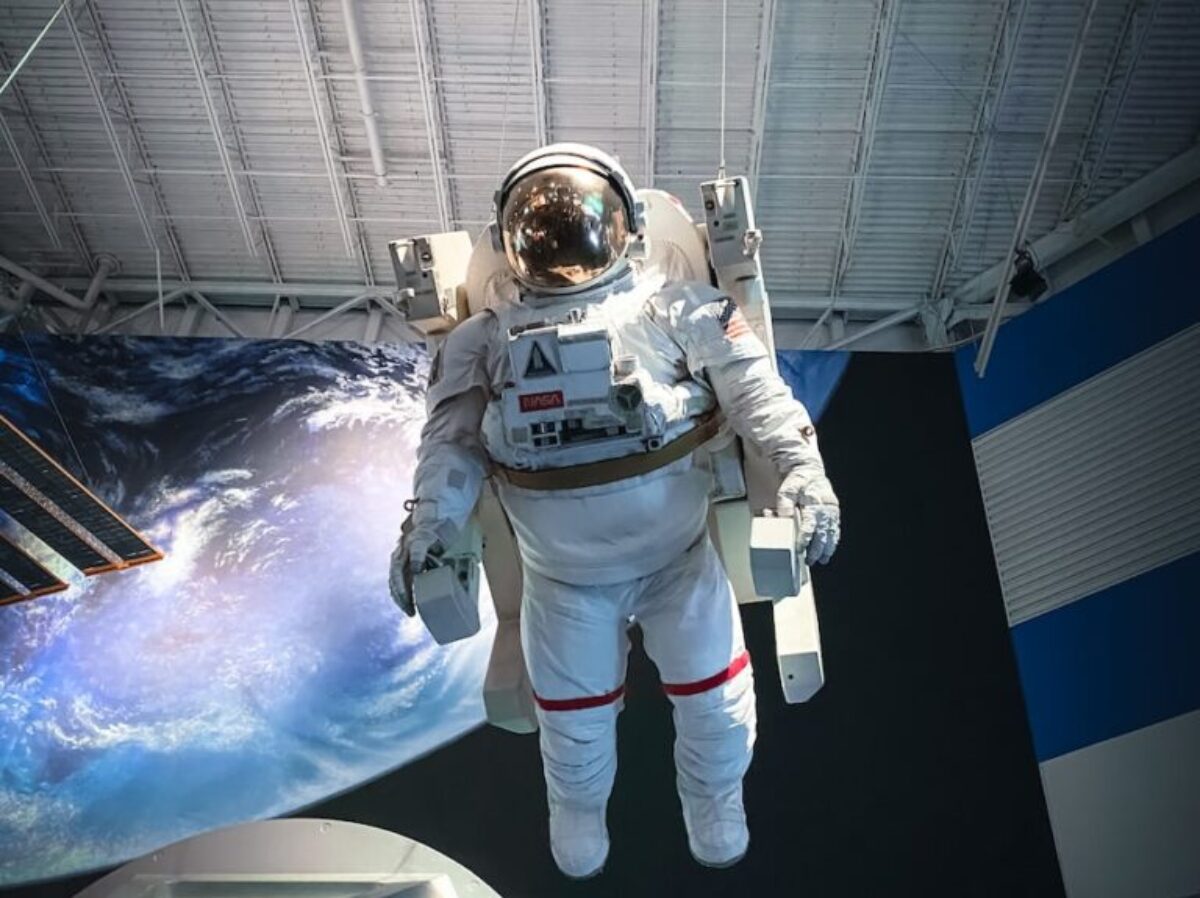 man in white and black suit standing on white and blue floor