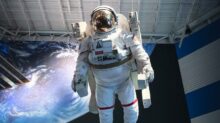 man in white and black suit standing on white and blue floor