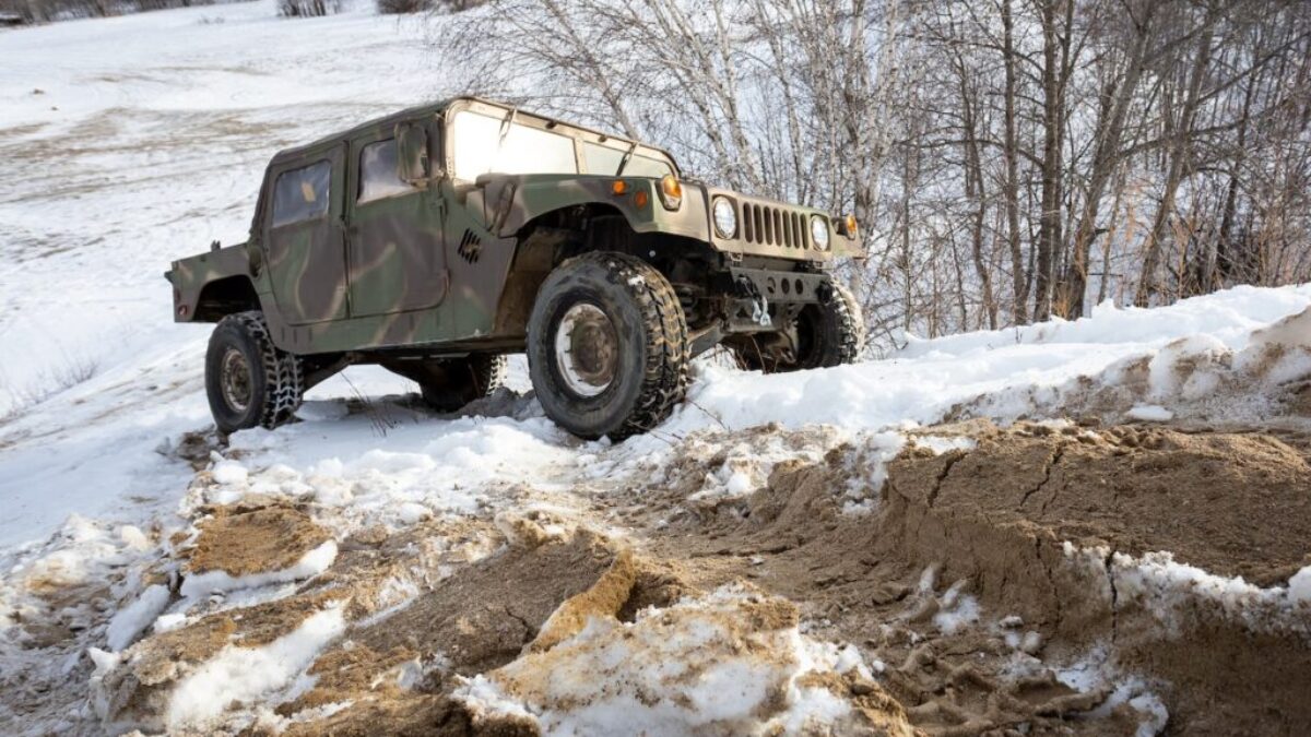 black and white jeep wrangler on snow covered ground during daytime