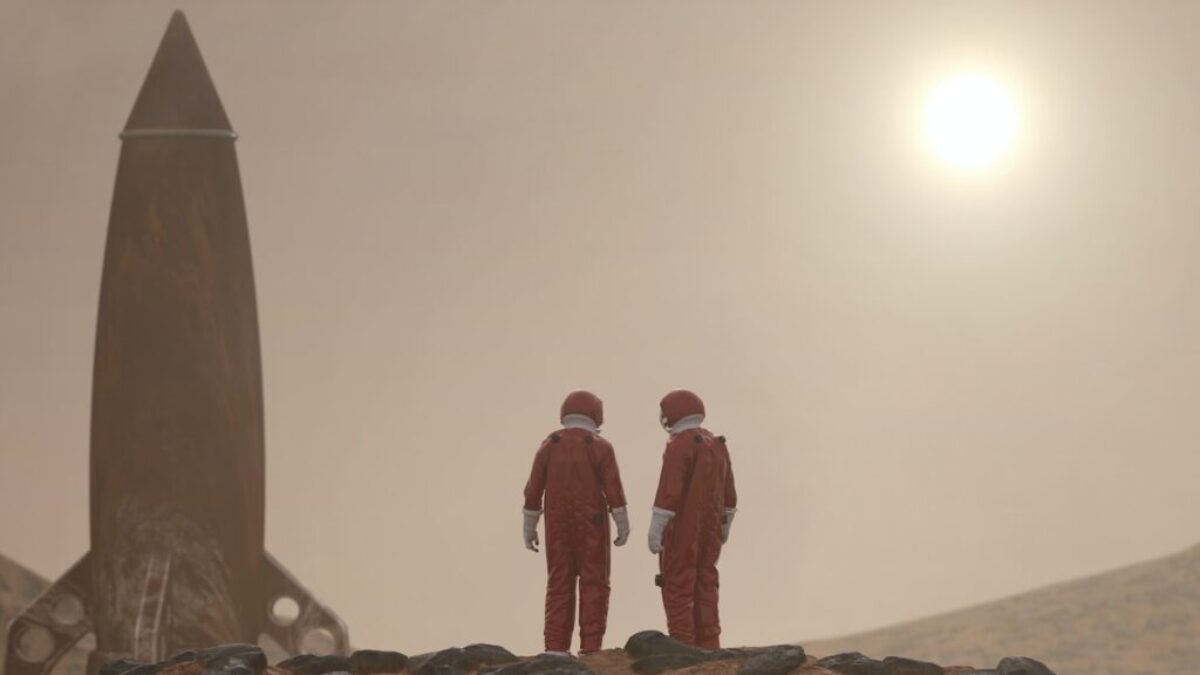 3 men standing on rocky shore during daytime