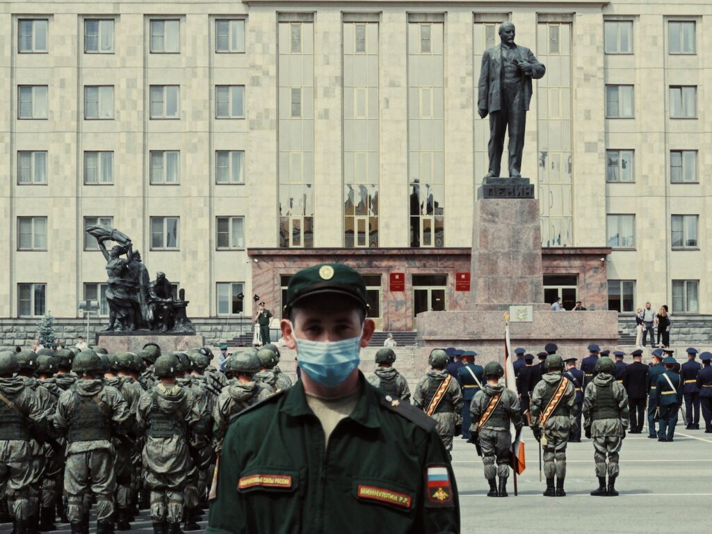 soldiers in black uniform standing near gray concrete building during daytime