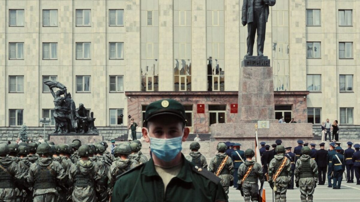 soldiers in black uniform standing near gray concrete building during daytime