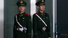 man in black and brown camouflage uniform