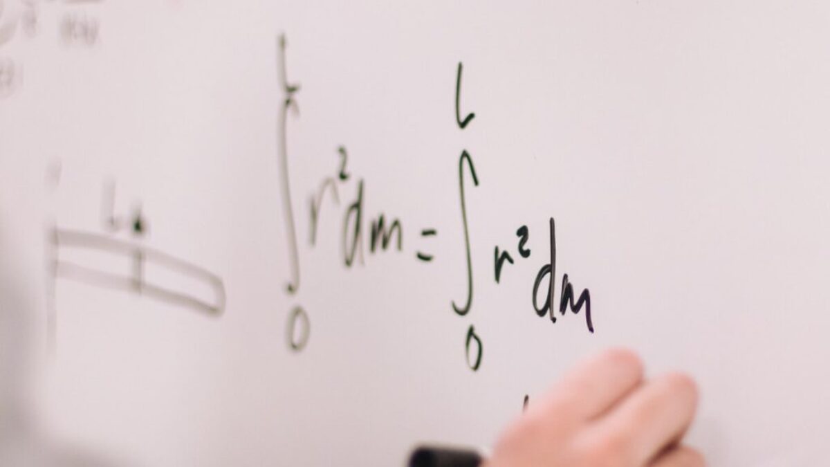 person writing on white paper