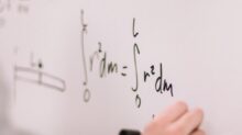 person writing on white paper