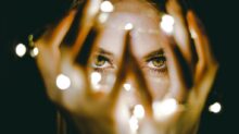 woman holding string lights