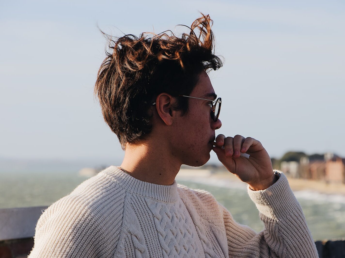 man wearing white cable-knitted top