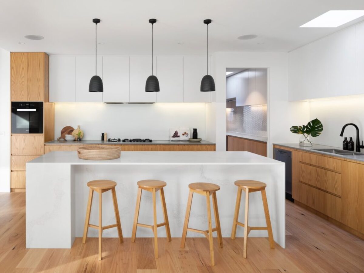 brown wooden seat beside white wooden table