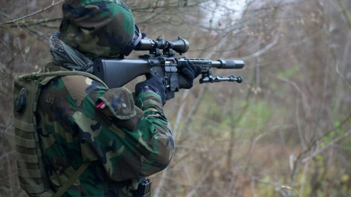 person holding assault rifle