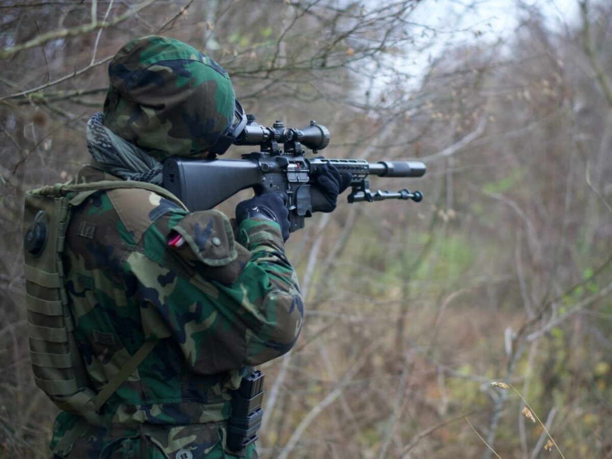 person holding assault rifle