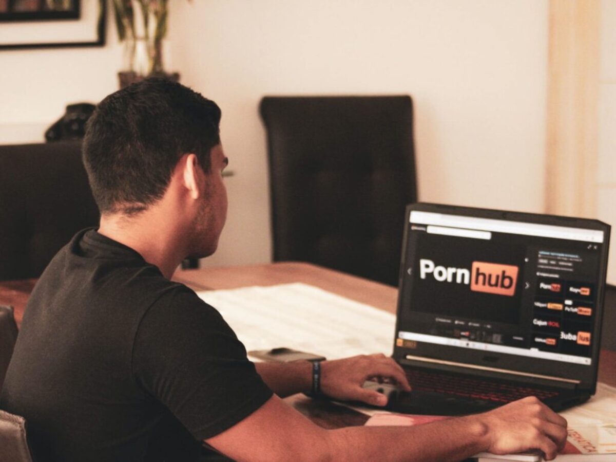 man in black t-shirt using black laptop computer