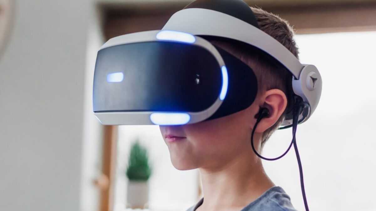 boy wearing black and white VR headset