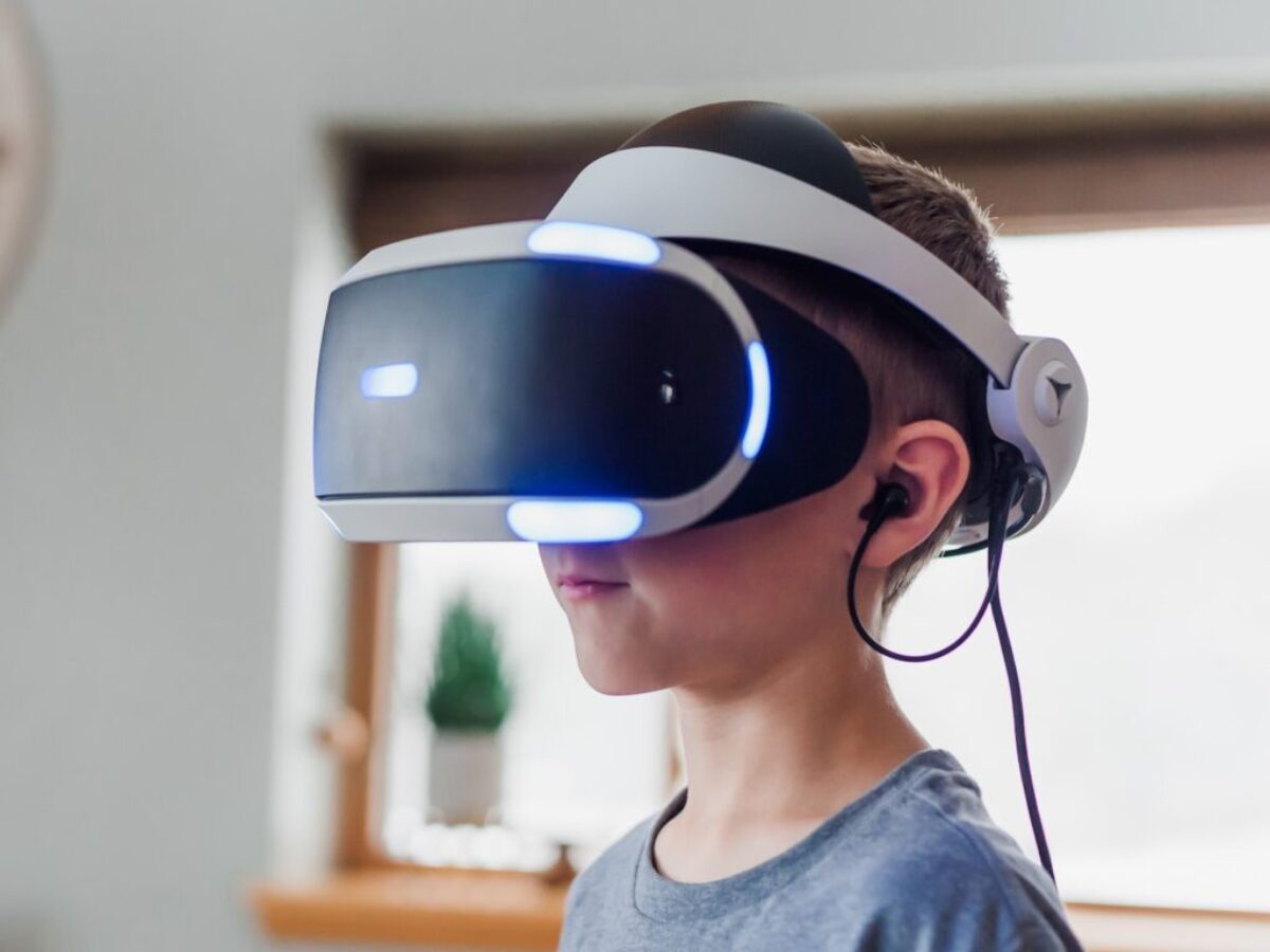 boy wearing black and white VR headset