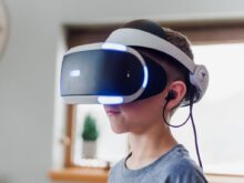 boy wearing black and white VR headset