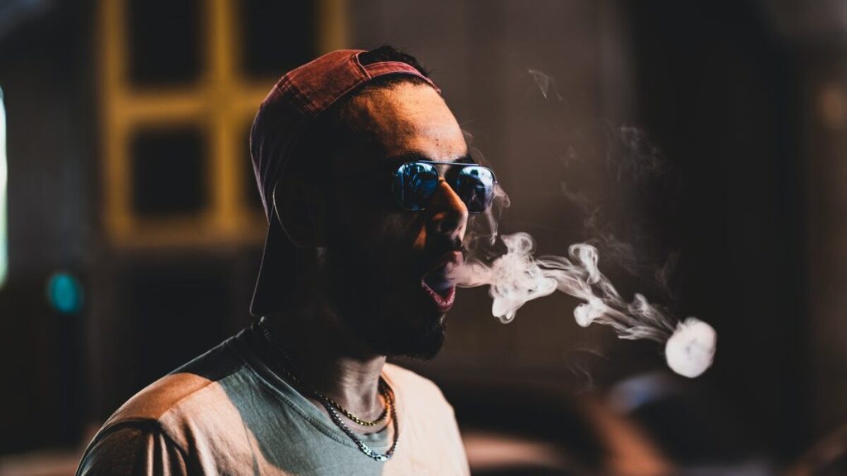 man in white crew neck shirt wearing black sunglasses