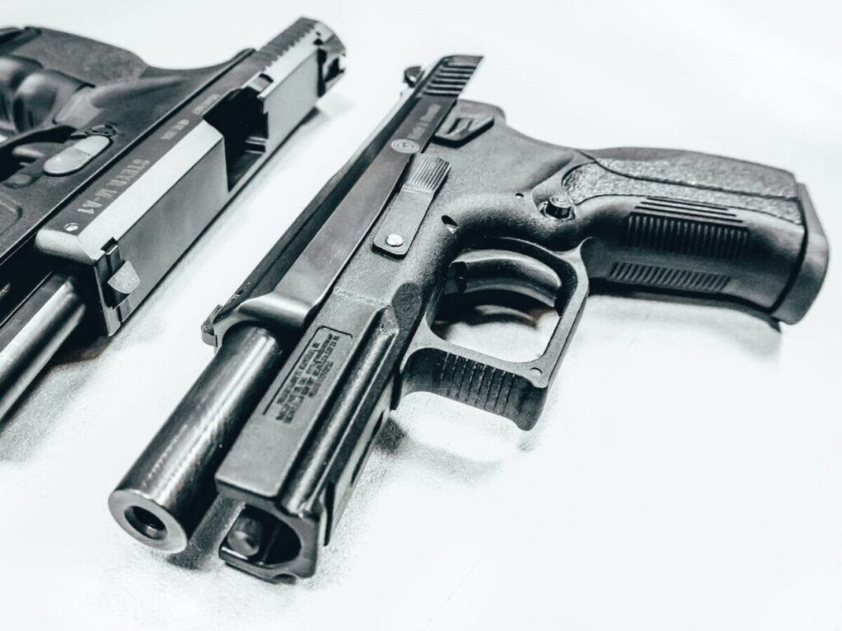 black semi automatic airsoft pistol on white textile