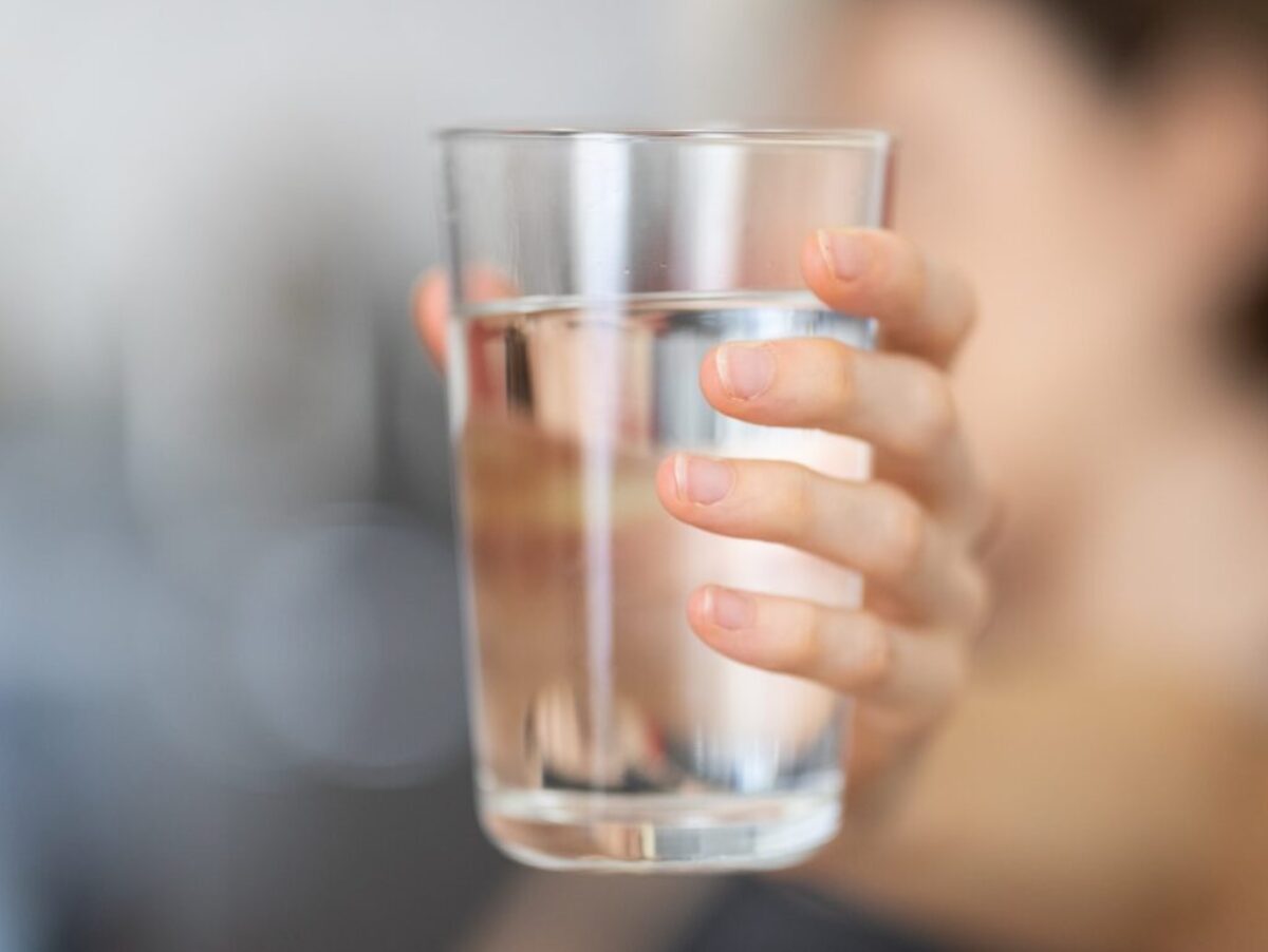person holding clear drinking glass