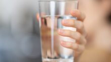 person holding clear drinking glass