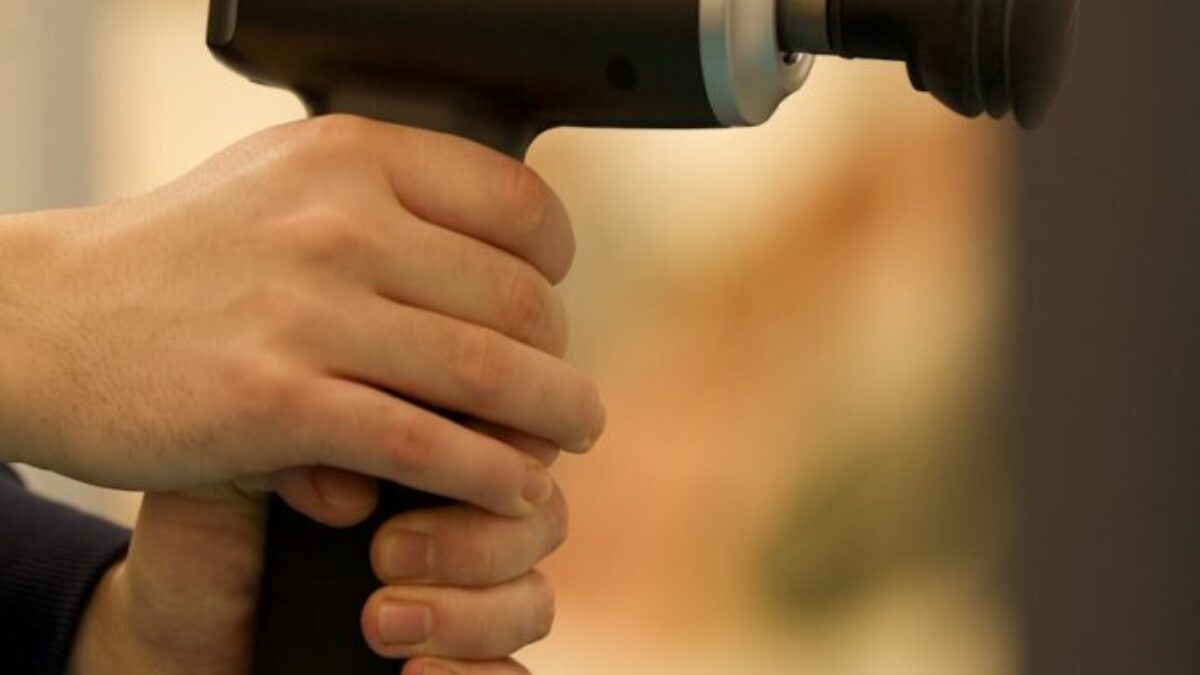 person holding black and gray cordless hand drill