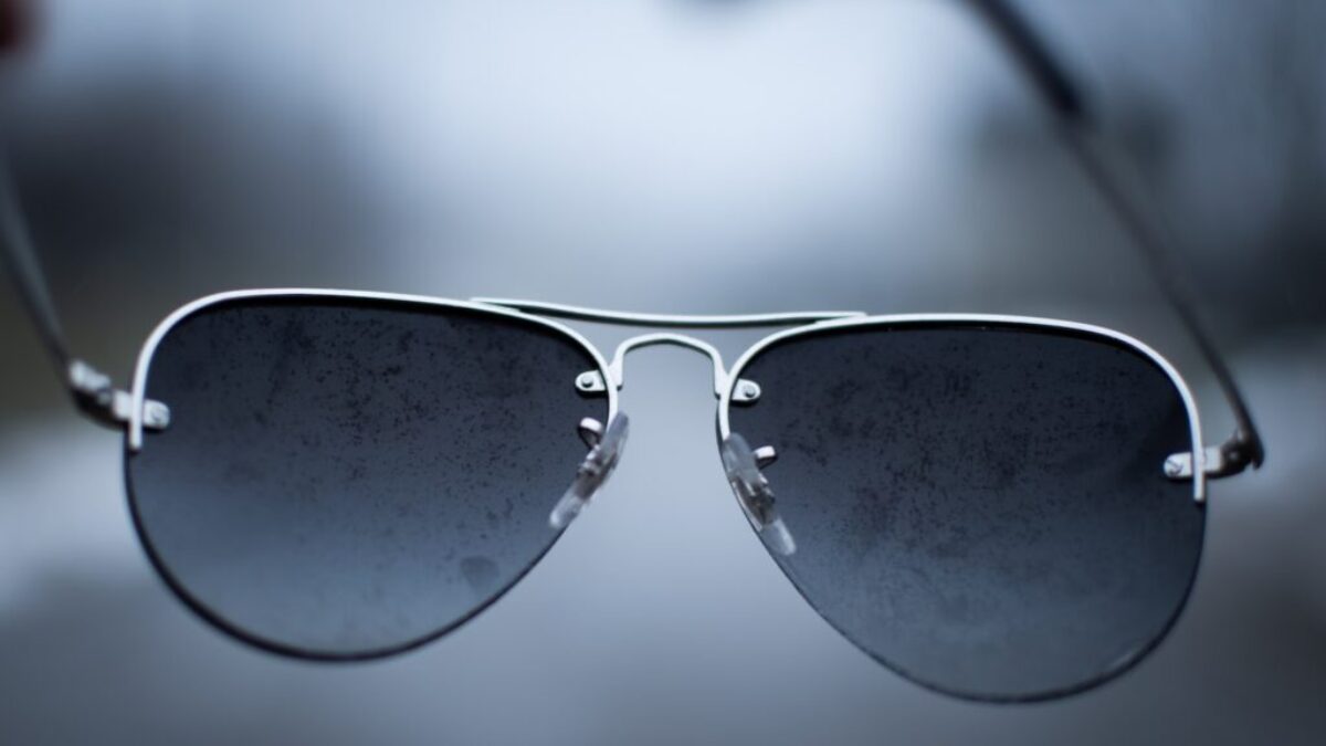 black framed sunglasses on white surface