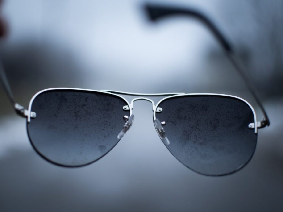 black framed sunglasses on white surface