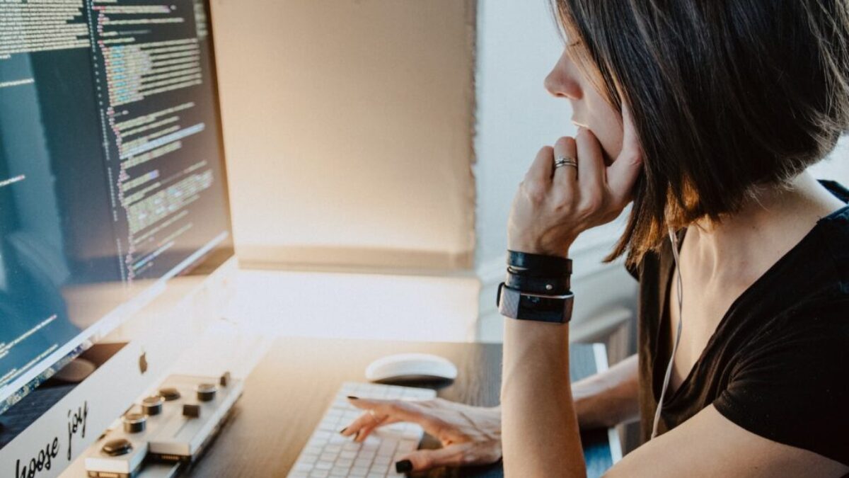 woman wearing black t-shirt holding white computer keyboard