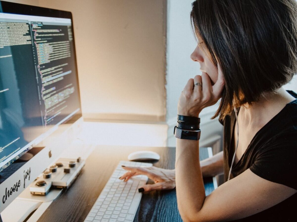 woman wearing black t-shirt holding white computer keyboard