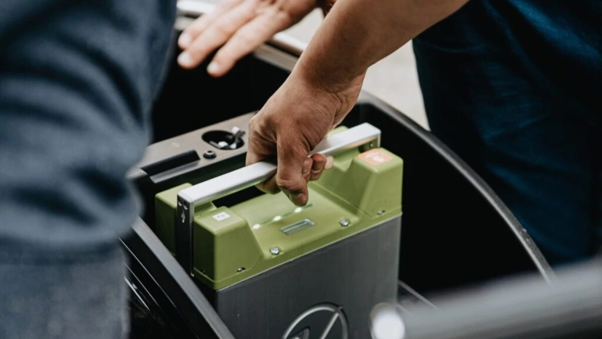 person holding black and green electronic device