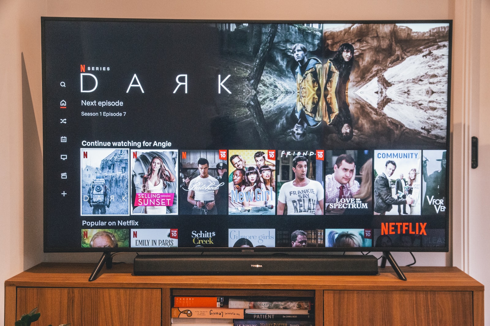 - Techsvět black flat screen tv turned on displaying man in black suit