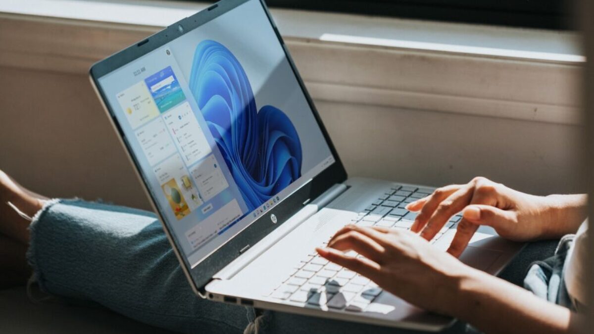 person using Windows 11 computer on lap