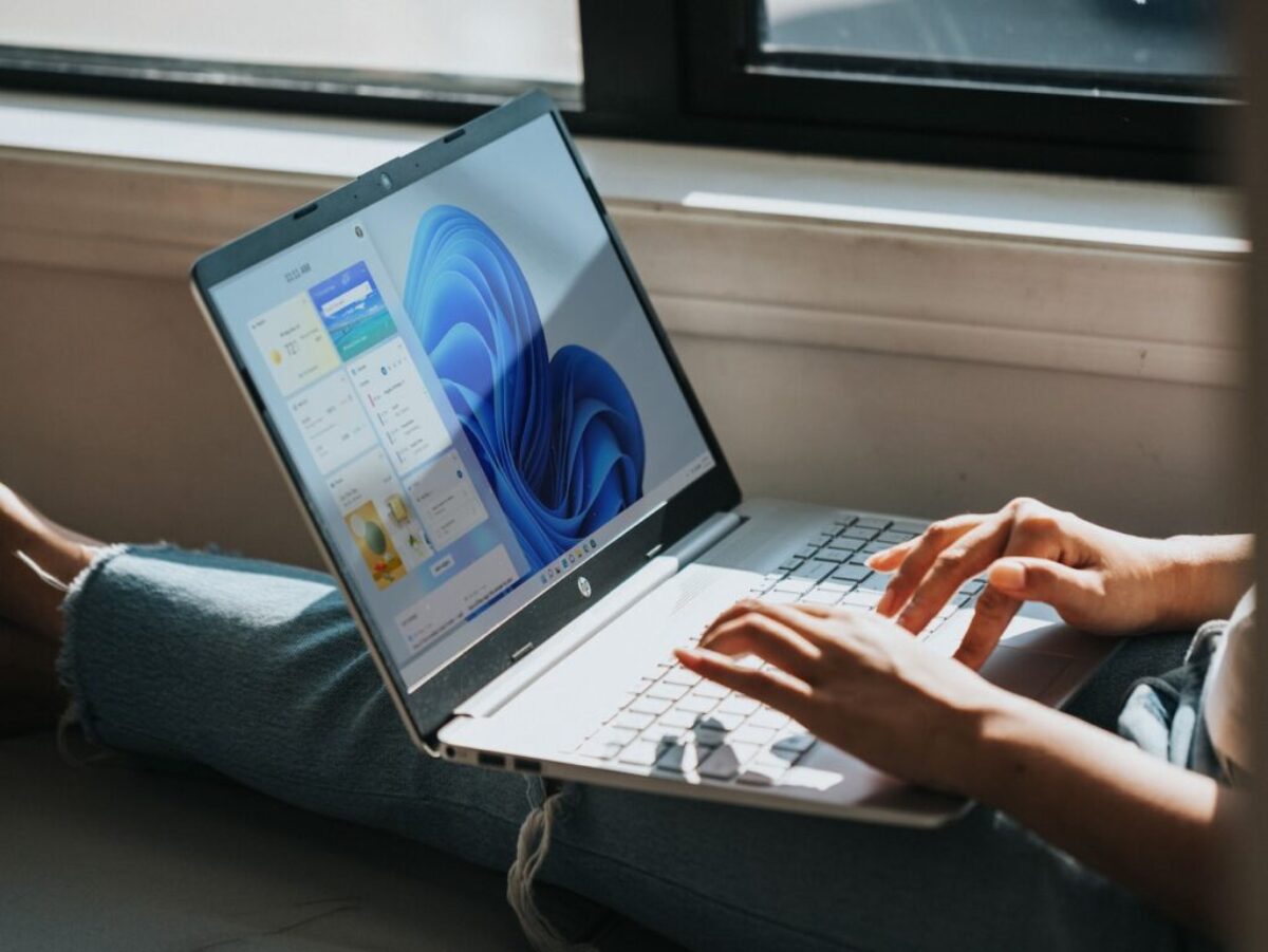 person using Windows 11 computer on lap