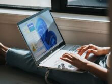 person using Windows 11 computer on lap