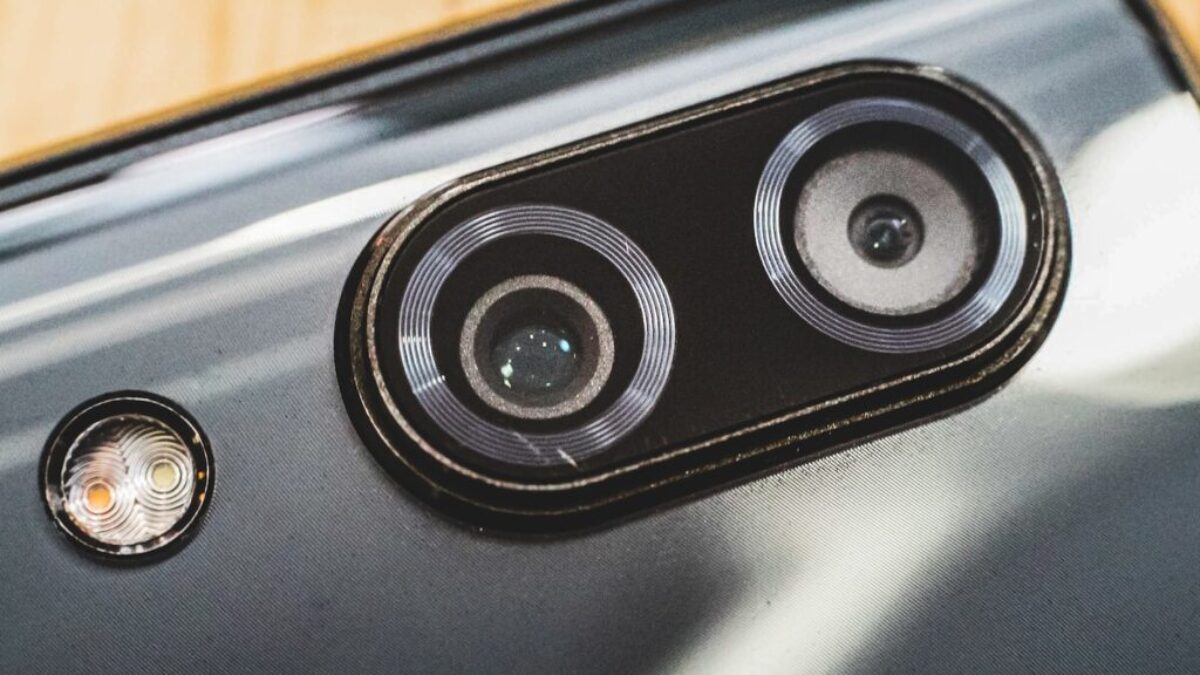 black and silver speaker on brown wooden table