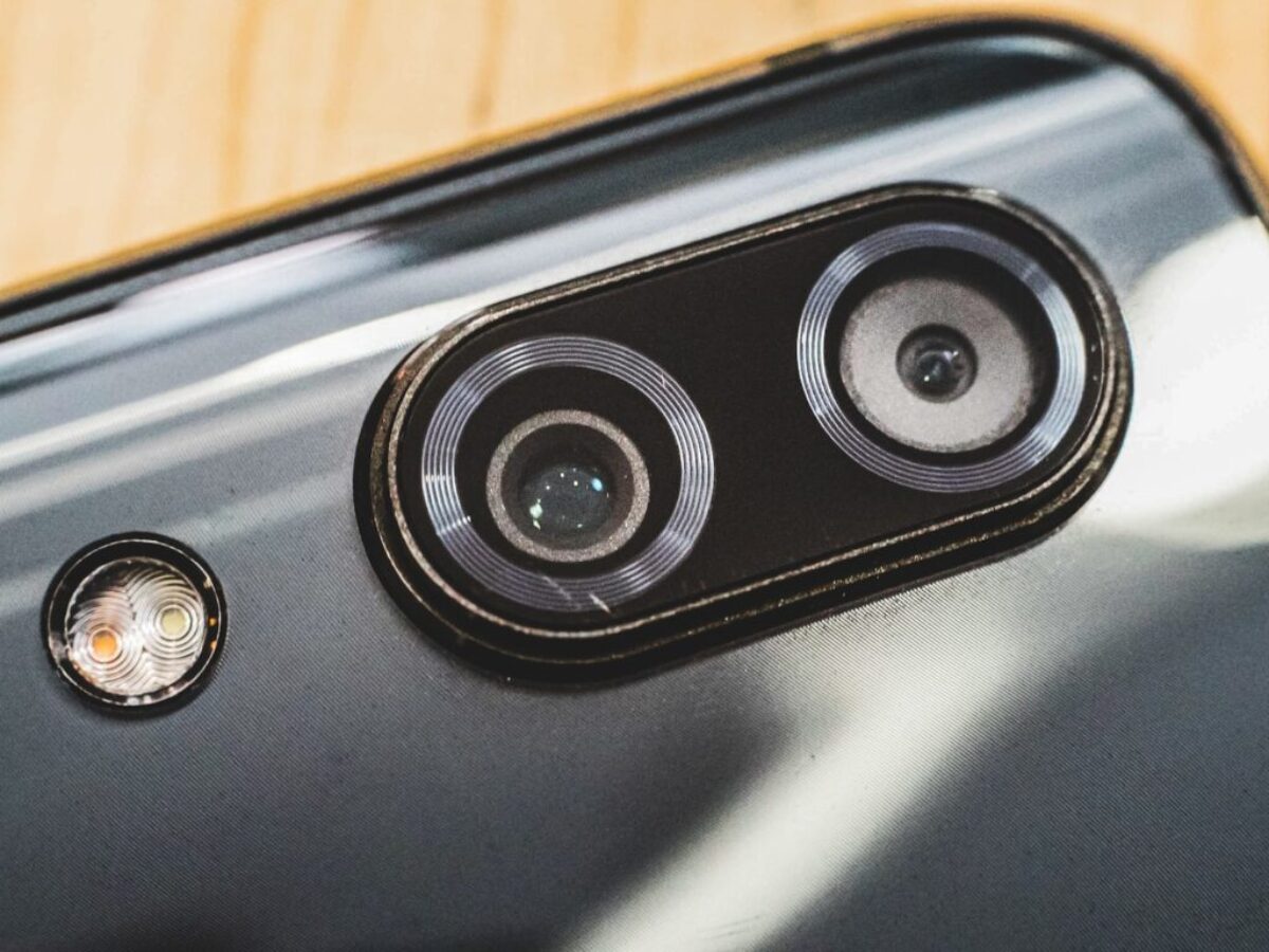 black and silver speaker on brown wooden table