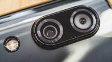 black and silver speaker on brown wooden table