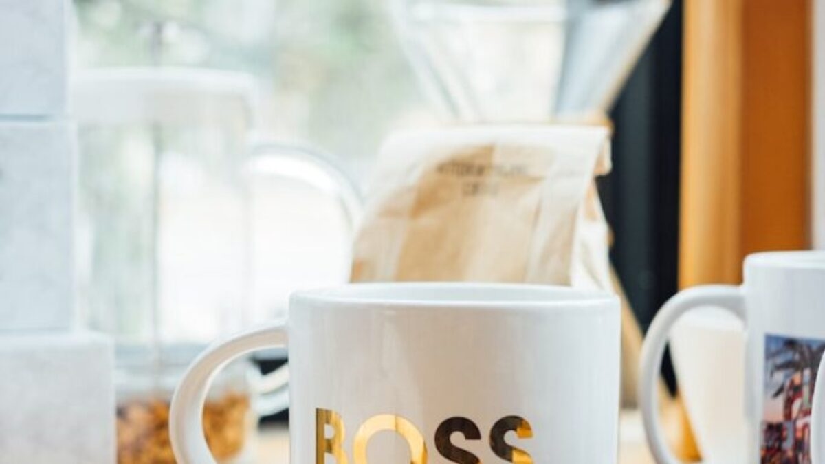 white Boss-printed ceramic mug on brown surface
