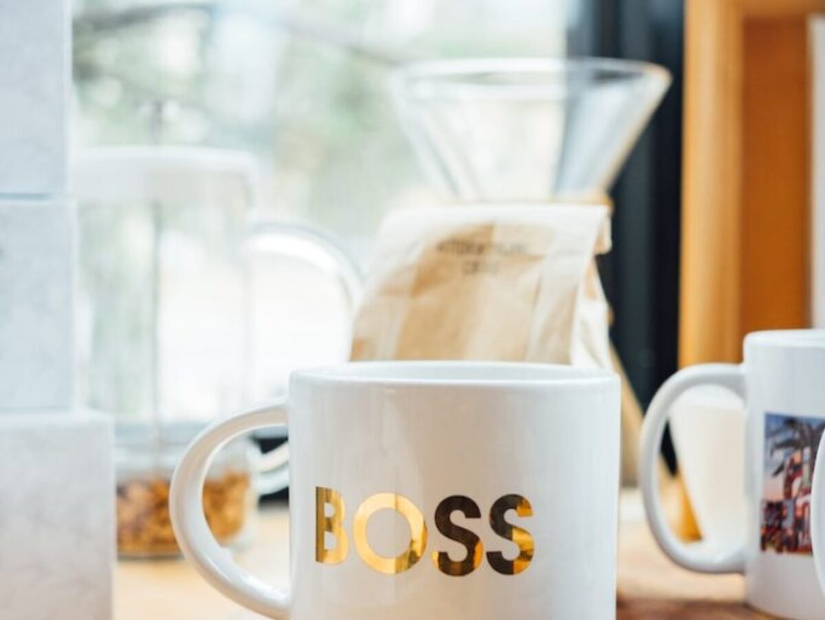white Boss-printed ceramic mug on brown surface