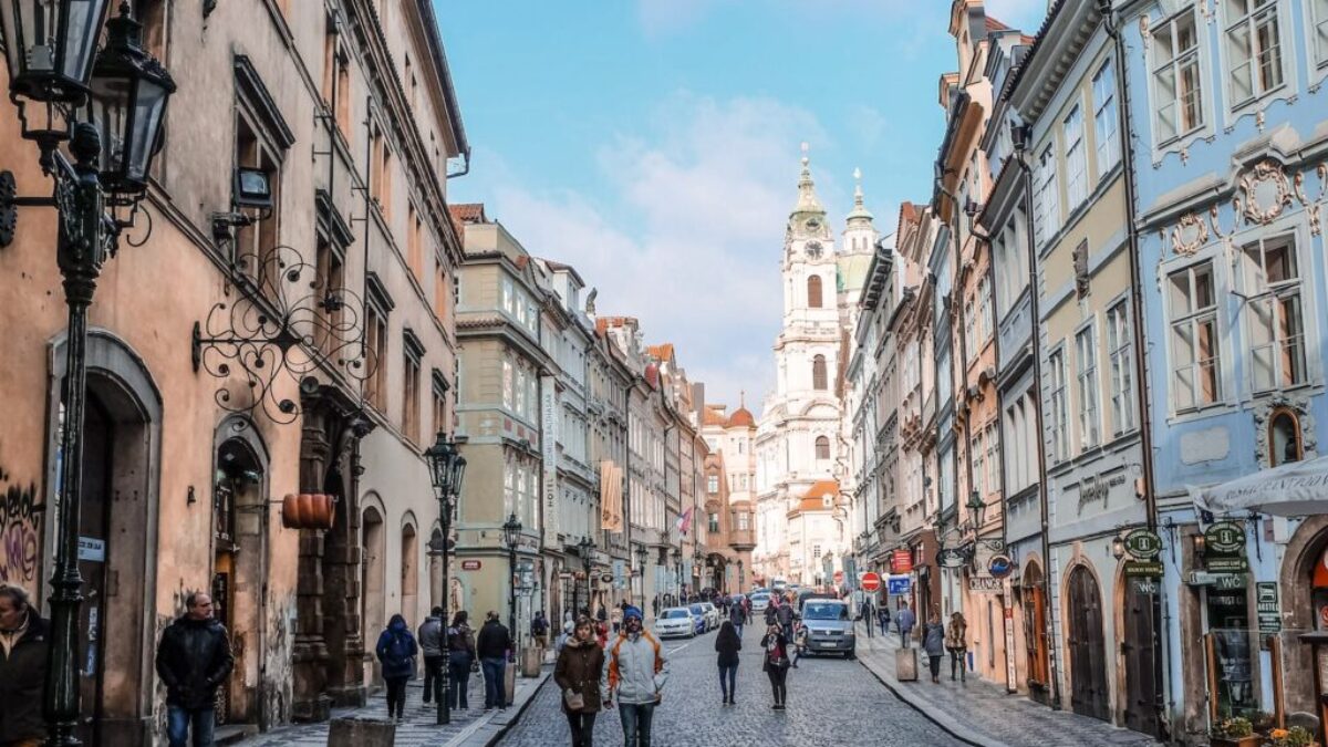 people walking on street between buildings during daytime