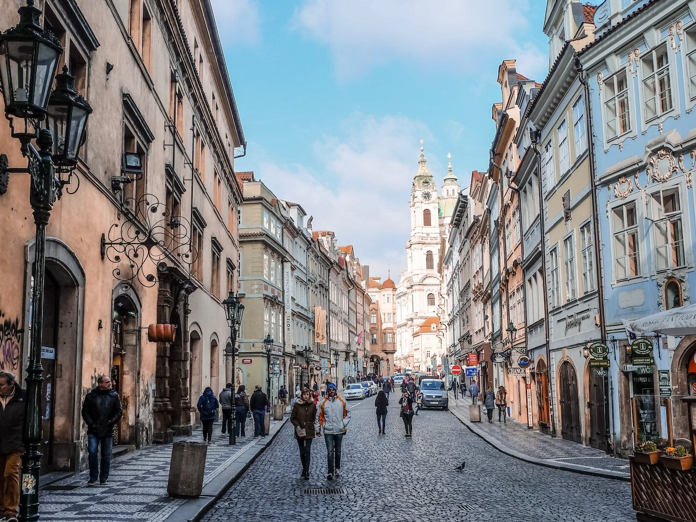 people walking on street between buildings during daytime