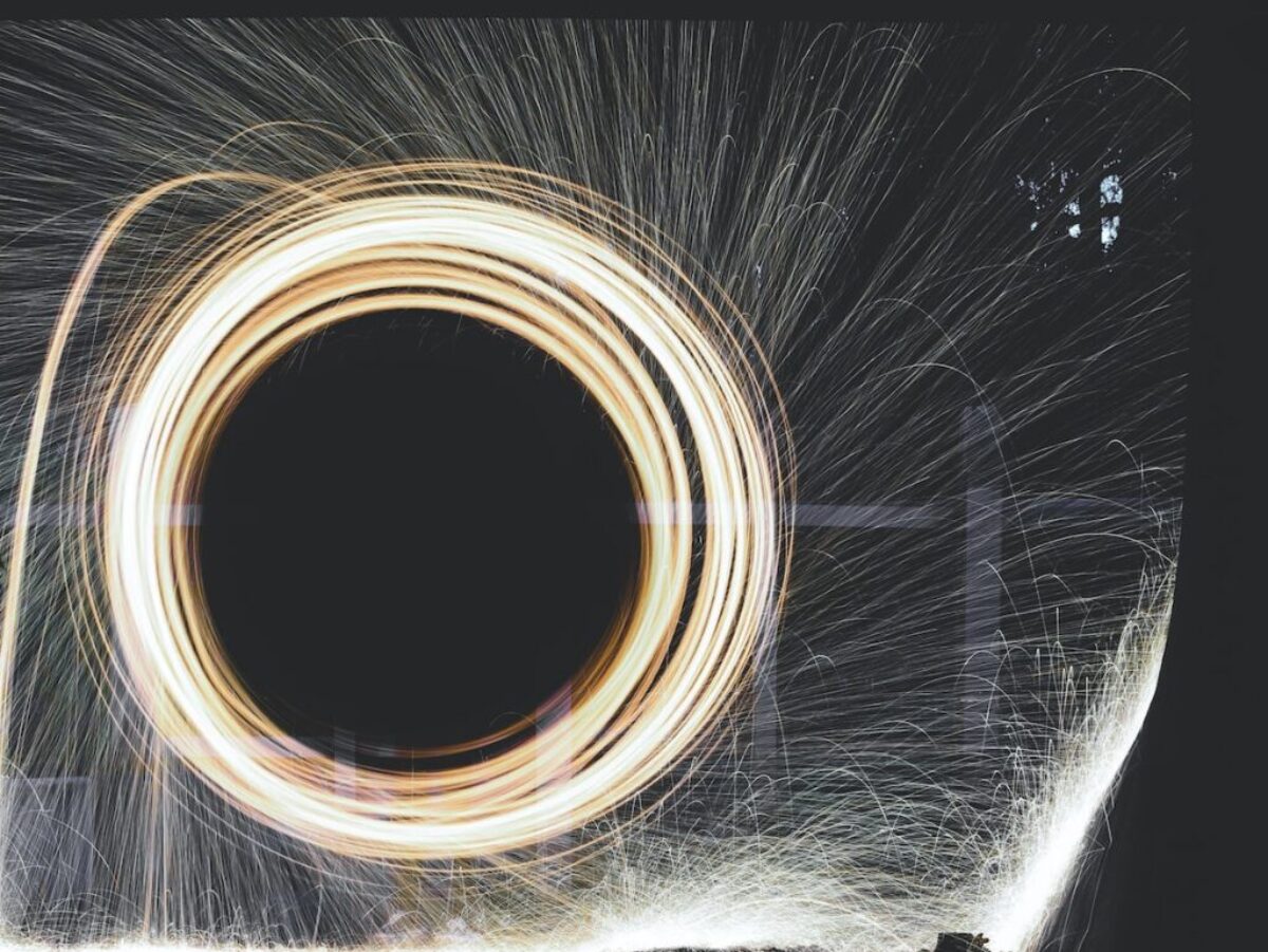 photo of person holding umbrella near steelwool during nighttime