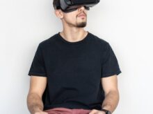 man sitting and using black virtual reality headset