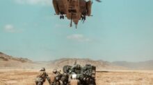 black and brown helicopter flying over brown field during daytime