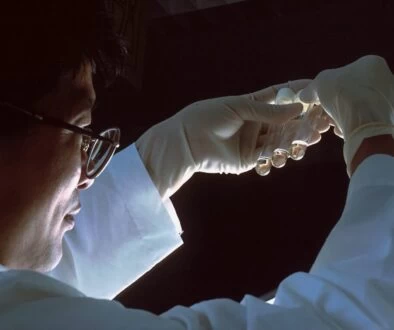 person in brown long sleeve shirt wearing silver framed eyeglasses